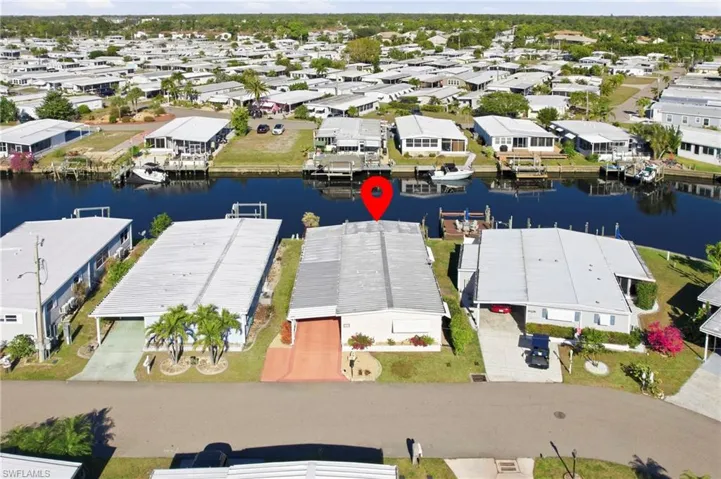 Aerial view of residential area featuring a nearby body of water