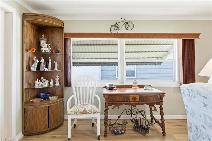 Sitting room featuring light wood-type flooring and baseboards
