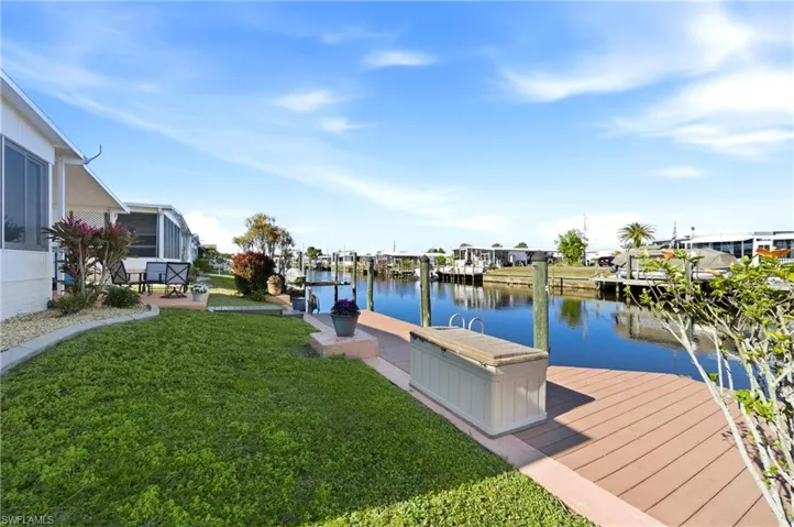 Dock area featuring a lawn and a water view