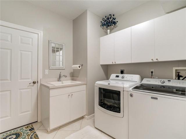 LAUNDRY ROOM WITH LAUNDRY TUB AND STORAGE CABINETS