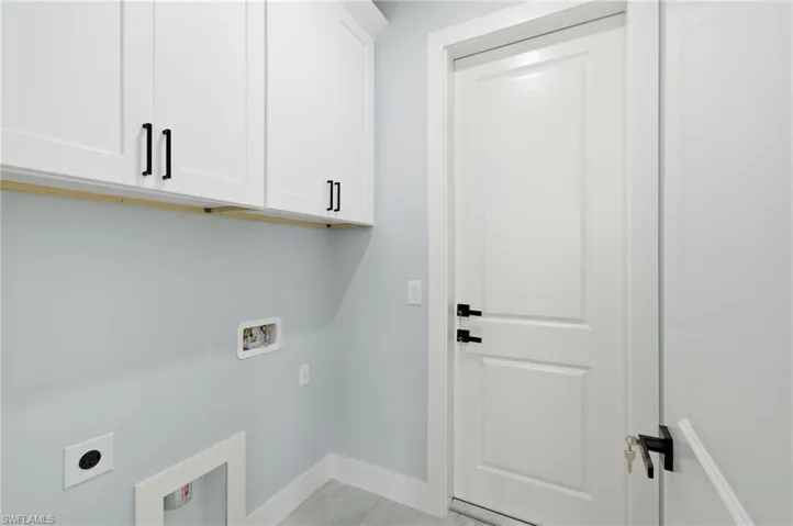 Laundry room featuring cabinet space, electric dryer hookup, and washer hookup