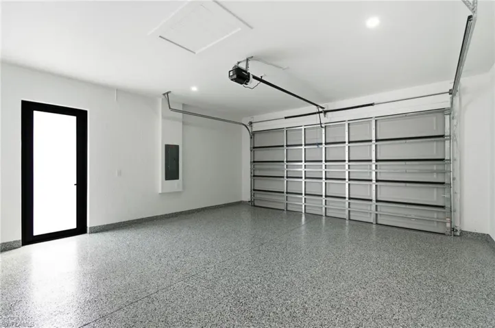 Garage with electric panel and a garage door opener