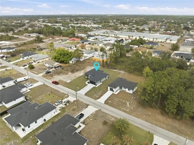 Aerial view of property's location featuring nearby suburban area
