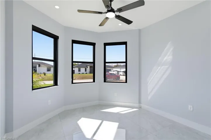 Empty room featuring a ceiling fan and recessed lighting