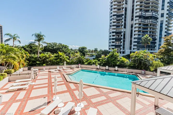 Community pool with a patio