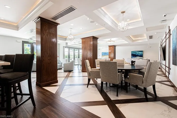 Common area dining room with bar. Access to pool and outside grills.