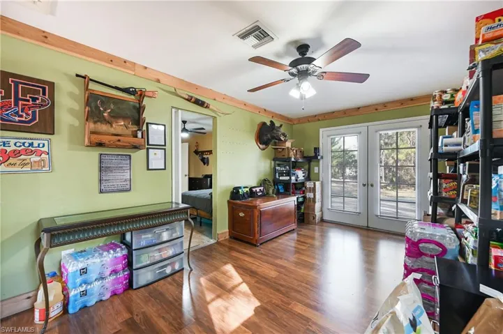 Office with french doors, ceiling fan, and wood finished floors