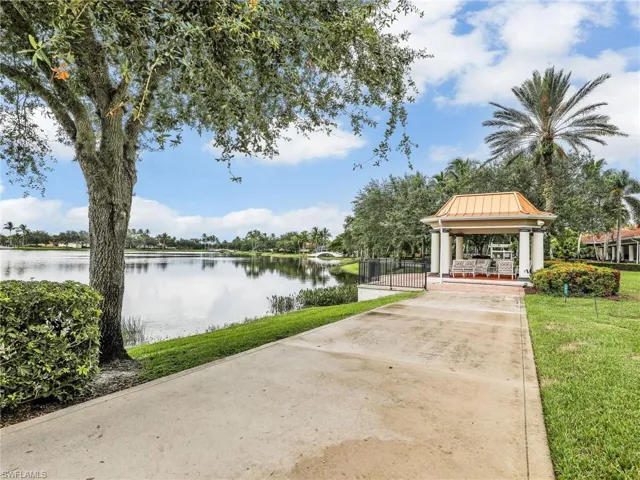 View of property's community featuring a gazebo, a lawn, and a water view