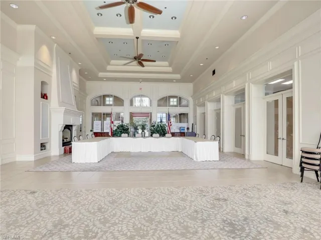 Reception area featuring ceiling fan and french doors