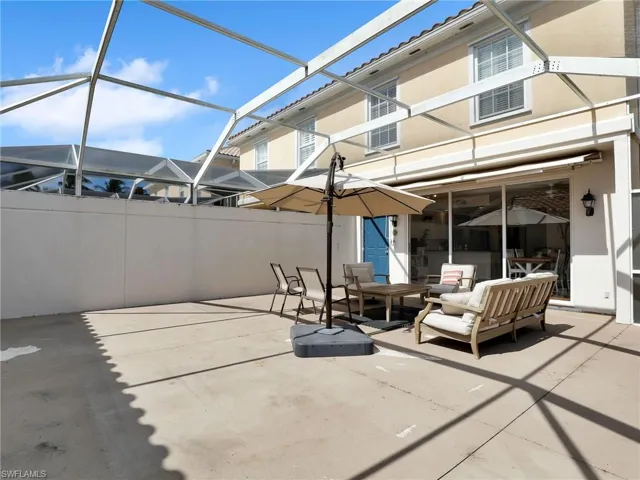 View of patio with outdoor lounge area and glass enclosure