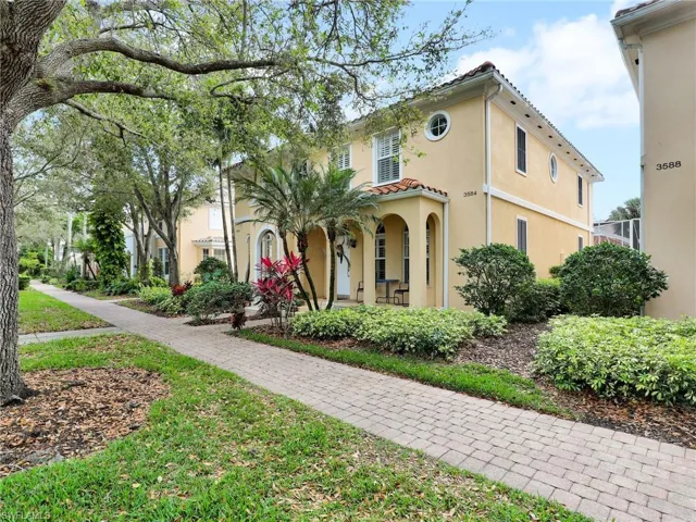 Mediterranean / spanish home with a porch and a front yard
