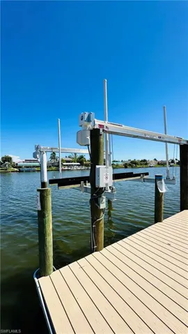 Waterfront access with a boat lift, composite decking, and sturdy pilings