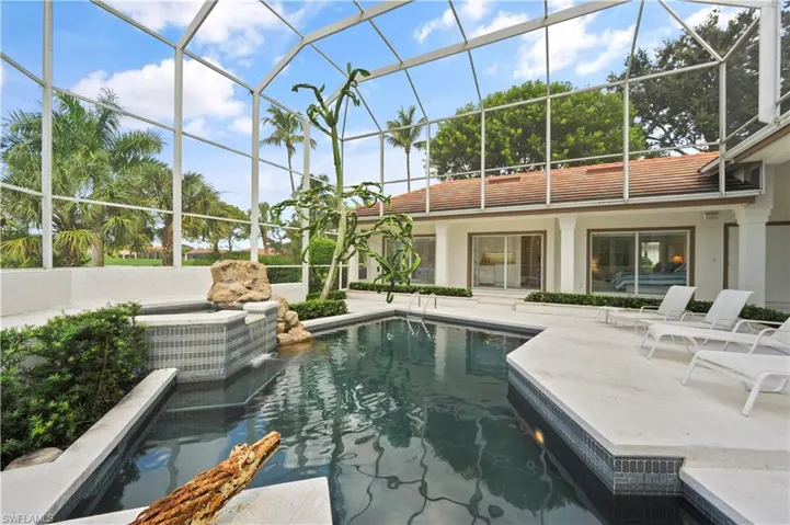 A sparkling pool takes center stage in this beautifully designed outdoor retreat.