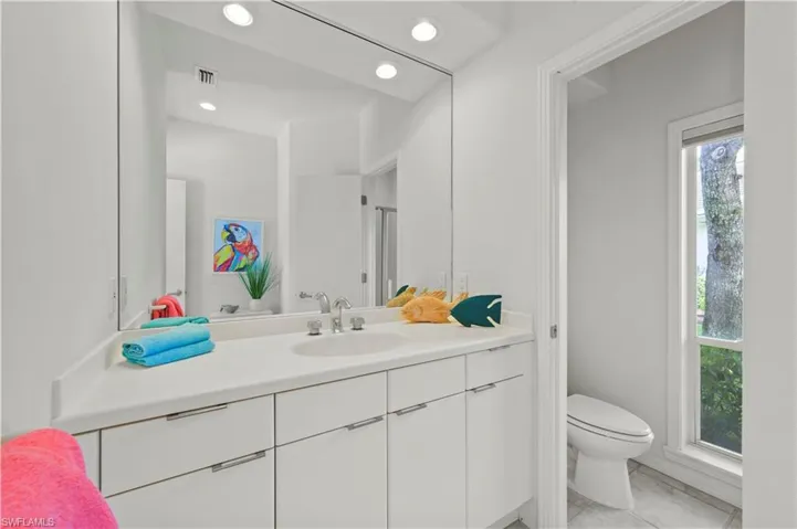A bright and spacious bath with plenty of storage.