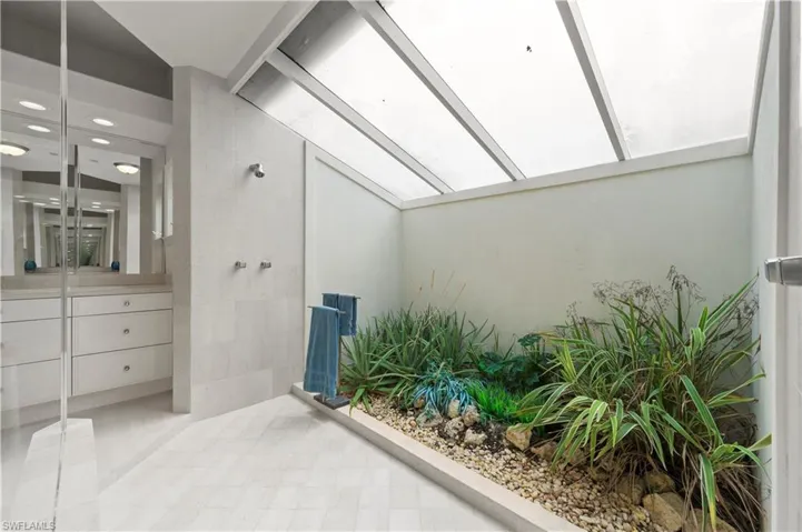 A private outdoor garden brings a touch of nature right into the primary bath!