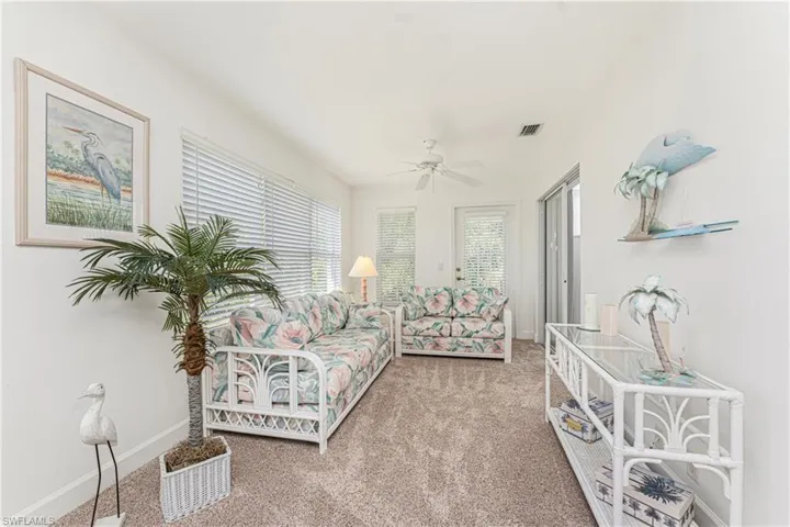 Living room featuring carpet and ceiling fan