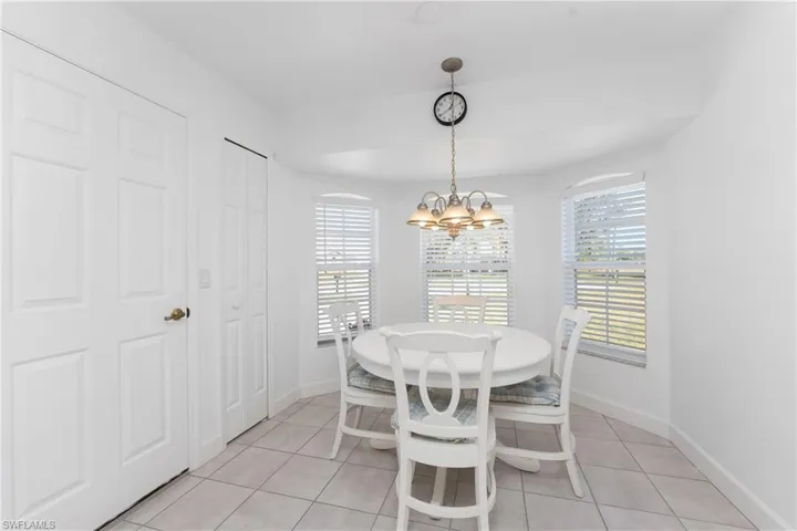 Tiled dining space with a chandelier