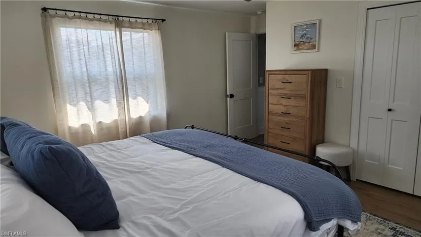 Bedroom with a closet and wood-type flooring