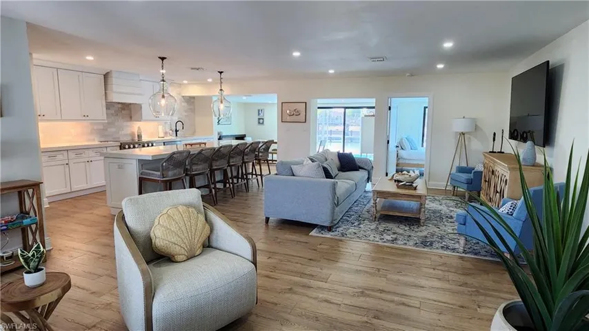Living room featuring sink and light LVP flooring