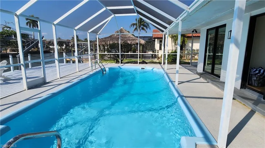 View of pool featuring a patio area and a lanai
