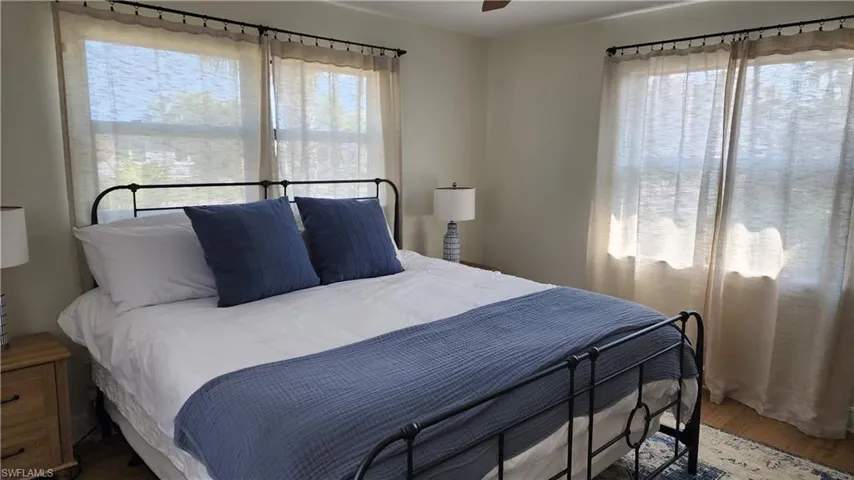 Bedroom with LVP flooring and ceiling fan