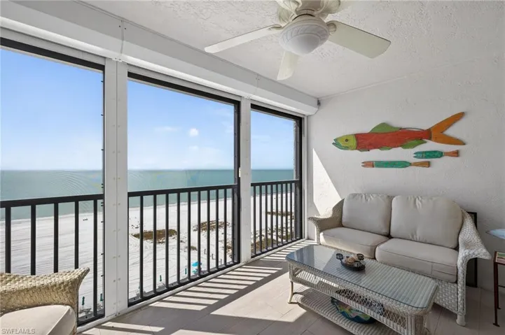 Balcony with view of water and beach