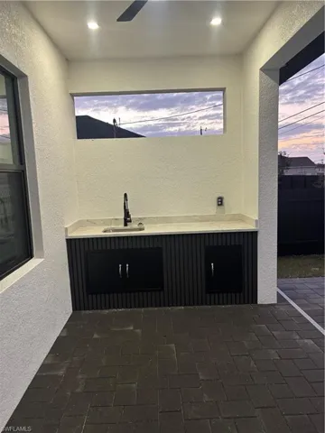 Patio terrace at dusk with a patio area and a sink