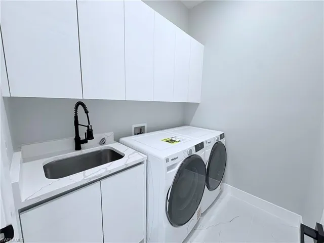 Laundry area with washing machine and clothes dryer and cabinet space