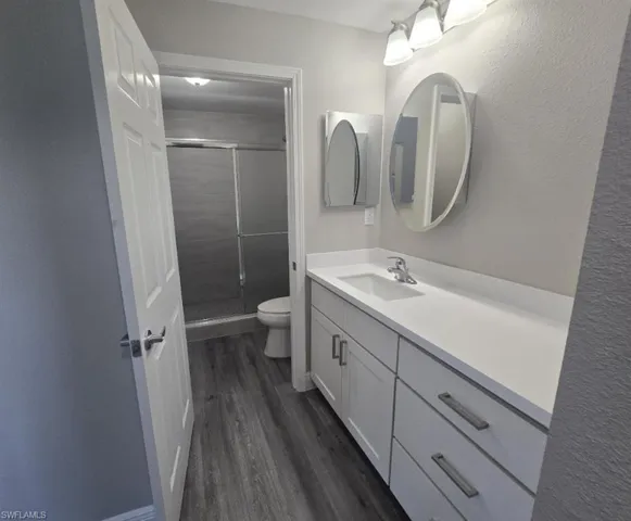 High Vanity with 2 mirrored cabinets, walk-in shower.