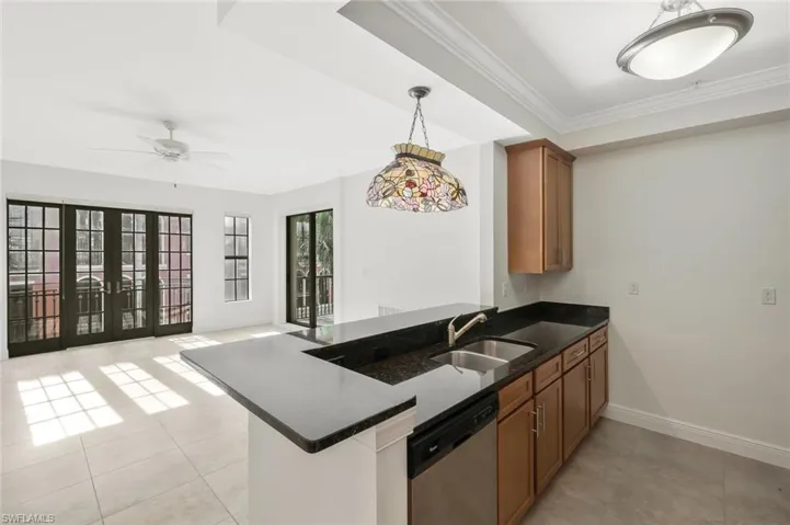 Kitchen with granite counter tops, stainless steel appliances, solid wood cabinetry and custom lighting