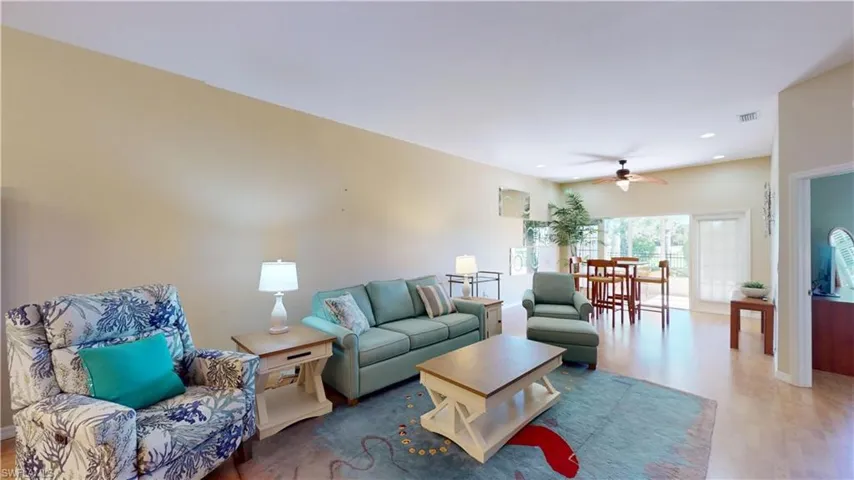 Living area featuring ceiling fan, wood finished floors, and recessed lighting