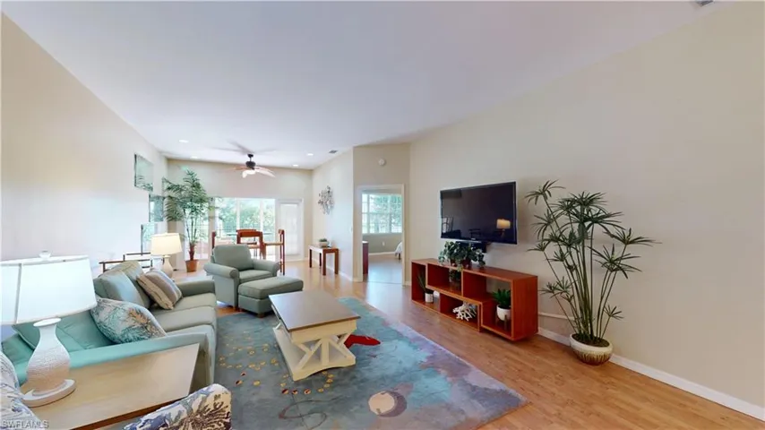 Living area featuring light wood-style floors, ceiling fan, and recessed lighting