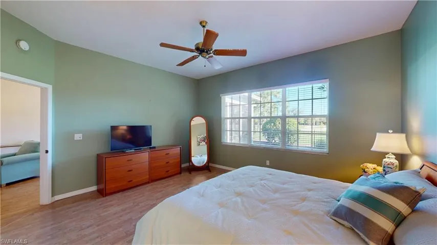 Bedroom with ceiling fan and light wood finished floors