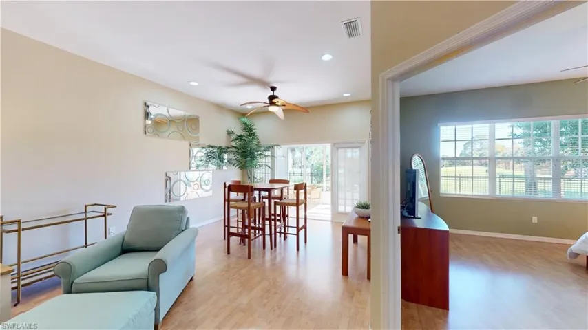 Dining area with ceiling fan, light wood finished floors, and recessed lighting