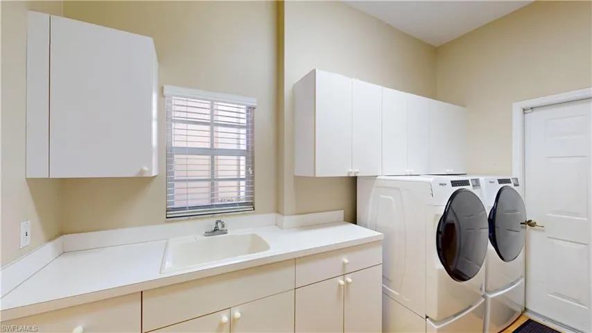 Laundry room with washing machine and clothes dryer and cabinet space