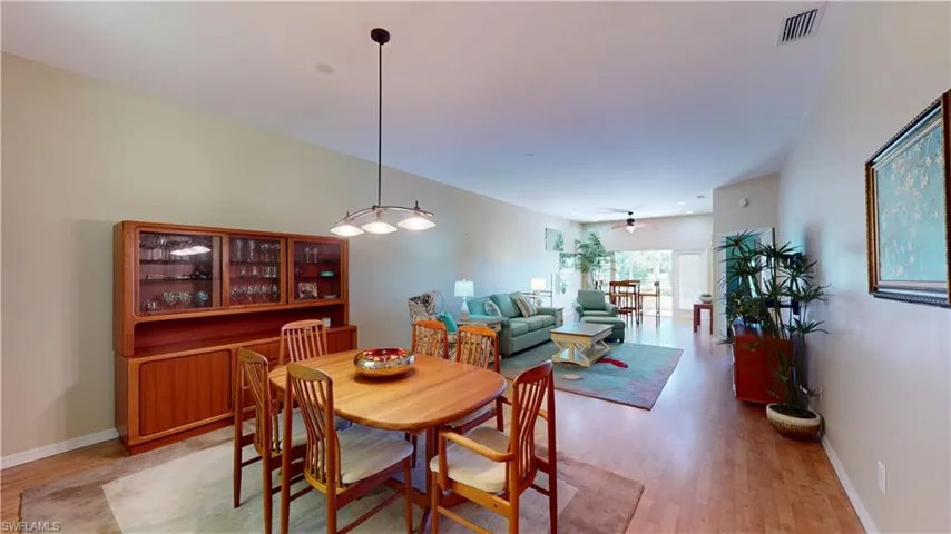 Dining space with light wood-style flooring and ceiling fan