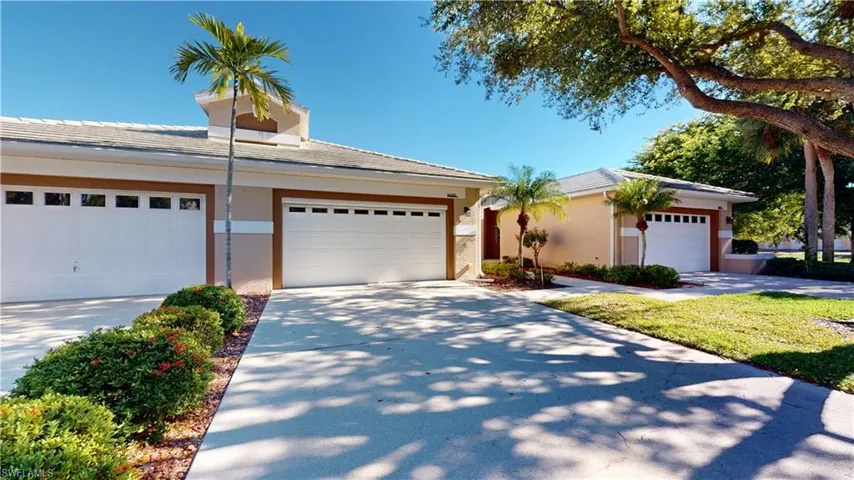 View of front facade featuring stucco siding, a garage, and driveway