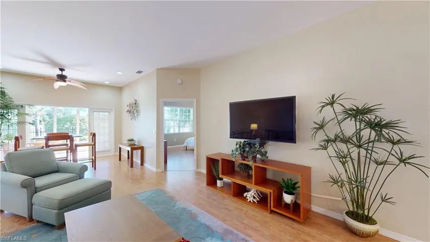 Living room with light wood-type flooring, a ceiling fan, and recessed lighting