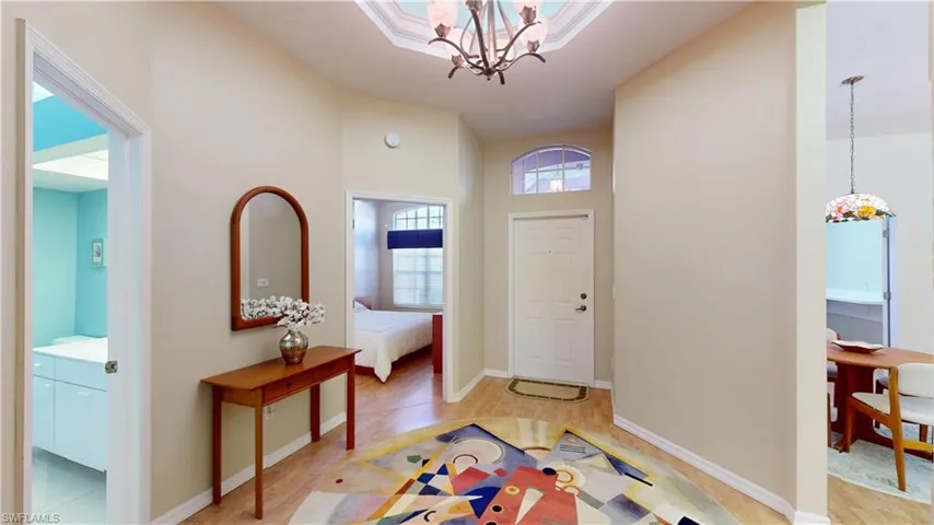 Foyer with a chandelier and light wood finished floors