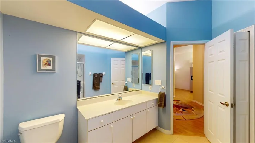 Full bath with vanity and light tile patterned floors