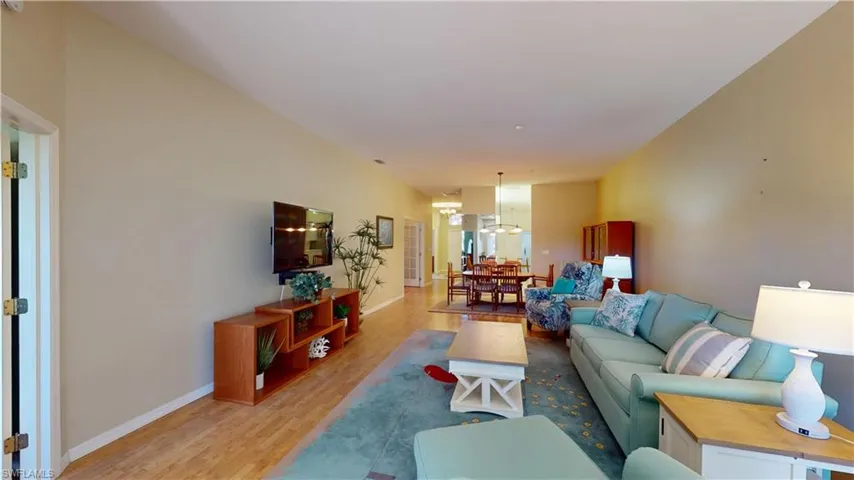 Living room featuring wood finished floors and a chandelier