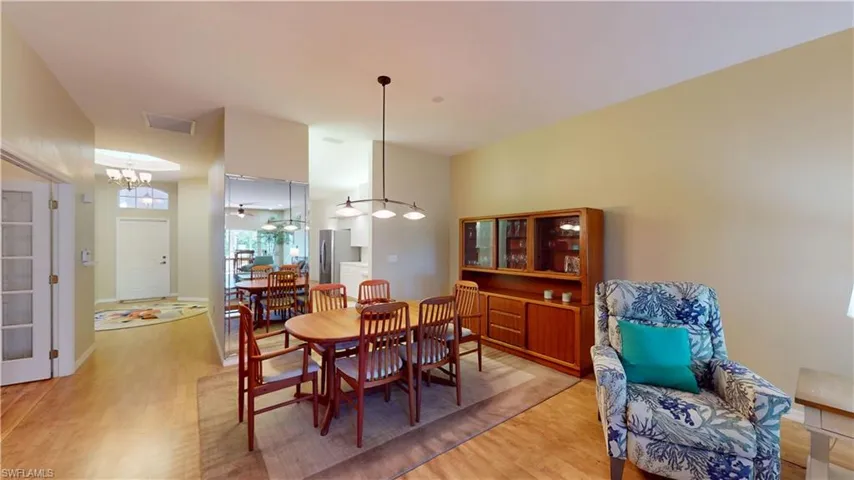 Dining space with light wood-style floors and baseboards