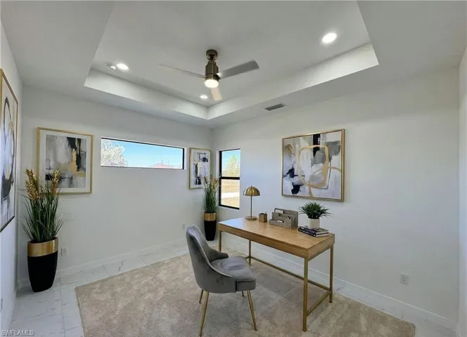 Office space featuring a ceiling fan and recessed lighting