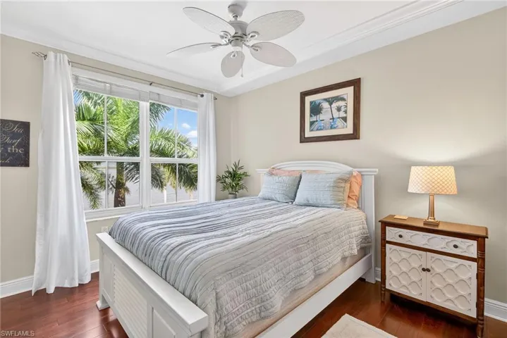 Bedroom with dark wood-style floors and ceiling fan