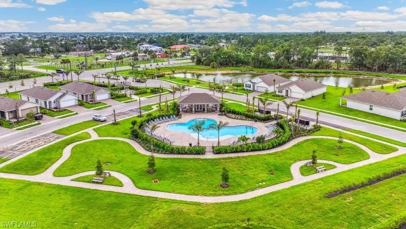 Aerial view of residential area featuring a large body of water and a pool