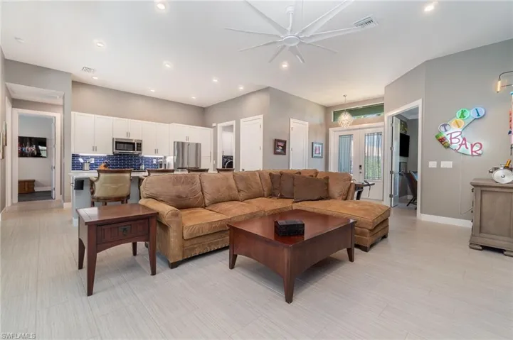Tiled living room open to the kitchen
