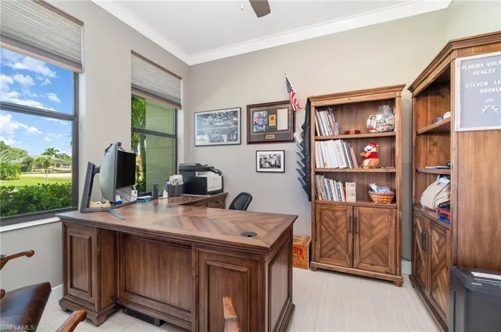 Office area featuring ceiling fan and ornamental molding