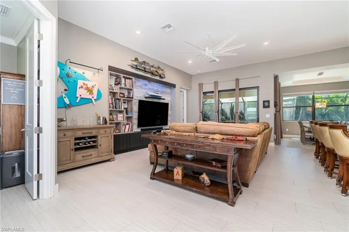 Living room with built in entertainment area & ceiling fan