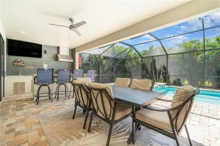 View lanai, dining area, summer kitchen and bar seating