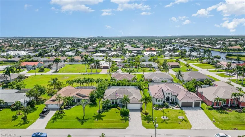 Birds eye view of property with a water view